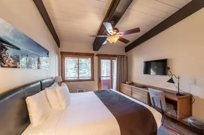 a bedroom with a bed and a ceiling fan at Granlibakken Tahoe in Tahoe City