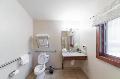 a white bathroom with a toilet and a sink at Granlibakken Tahoe in Tahoe City