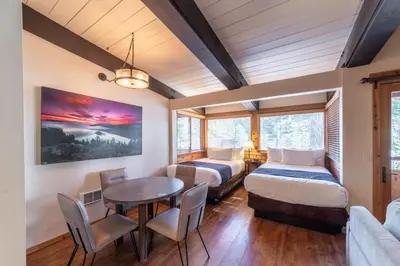 a room with two beds and a table and chairs at Granlibakken Tahoe in Tahoe City