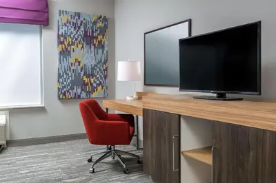 a room with a desk with a television and a chair at Hampton Inn & Suites Reno/Sparks in Reno