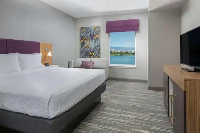 a hotel room with a bed and a flat screen tv at Hampton Inn & Suites Reno/Sparks in Reno