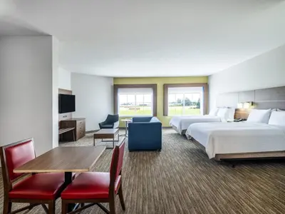 a hotel room with two beds and a table and chairs at Holiday Inn Express Lodi by IHG in Lodi
