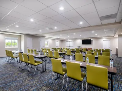 a conference room with tables and yellow chairs at Holiday Inn Express Lodi by IHG in Lodi