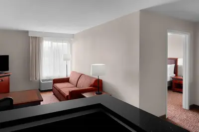 a living room with a couch and a chair in a hotel room at Larkspur Landing Extended Stay Suites Roseville in Roseville