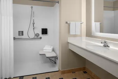 a white bathroom with a sink and a mirror at Larkspur Landing Extended Stay Suites Roseville in Roseville