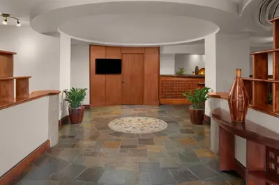 a large hallway with a lobby with a tv on the wall at Larkspur Landing Extended Stay Suites Sacramento in Sacramento