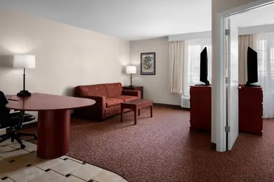 a living room with a couch and a table at Larkspur Landing Extended Stay Suites Sacramento in Sacramento