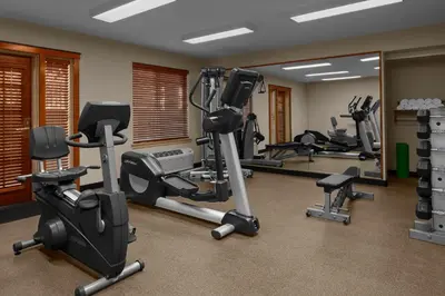 a gym with several treadmills and exercise bikes at Larkspur Landing Extended Stay Suites Sacramento in Sacramento