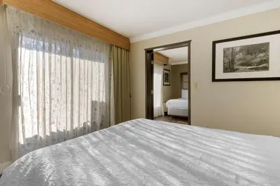 a bedroom with a bed and a window at Best Western Plus Forest Park Inn in Gilroy