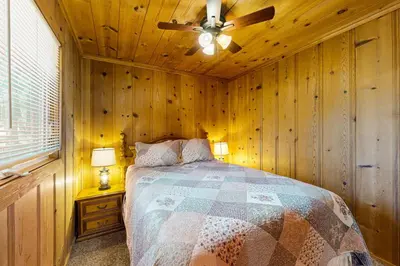 a bedroom with a bed and a ceiling fan at Cozy Seclusion in South Lake Tahoe