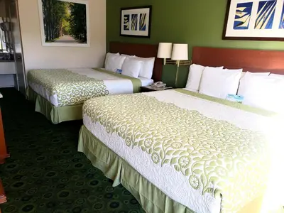 two beds sitting in a hotel room with at Days Inn by Wyndham Westley in Westley