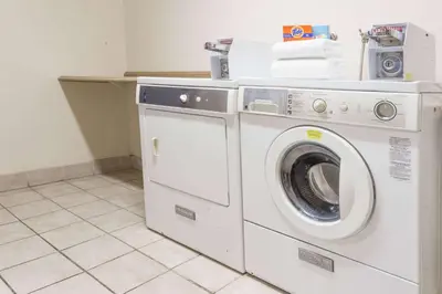 a washer and dryer in a laundry room at Days Inn by Wyndham Westley in Westley