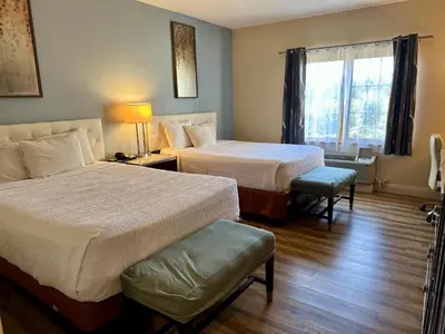 a hotel room with two beds and a window at Rocklin Park Hotel, Trademark Collection by Wyndham in Rocklin