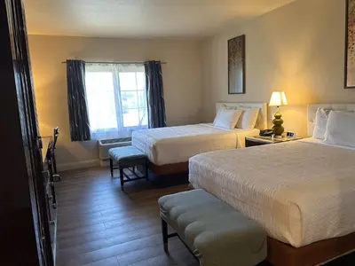 a hotel room with two beds and a window at Rocklin Park Hotel, Trademark Collection by Wyndham in Rocklin