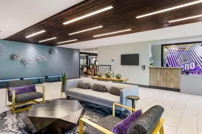 a lobby with a couch and chairs and a tv at Aiden by Best Western South Reno in Reno