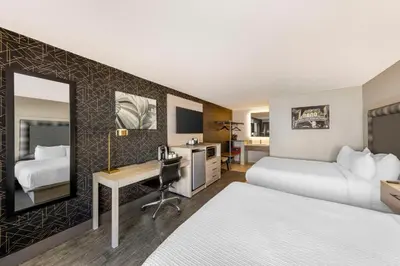 a hotel room with two beds and a desk at Aiden by Best Western South Reno in Reno