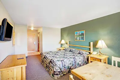 a hotel room with a bed and a table at Topaz Lodge in Gardnerville