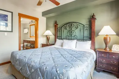 a bedroom with a large bed with a green headboard at Village 1401 in Mammoth Lakes