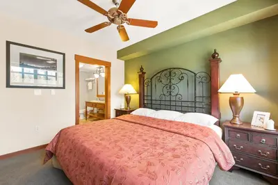 a bedroom with a large bed and a ceiling fan at Village 1401 in Mammoth Lakes
