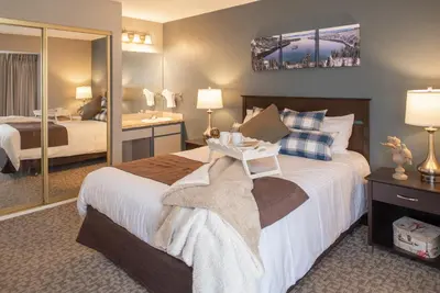 a hotel room with a large bed and a bathroom at Thunderbird Resort Club in Reno