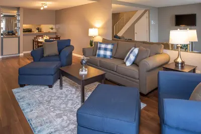 a living room with a couch and blue chairs at Thunderbird Resort Club in Reno