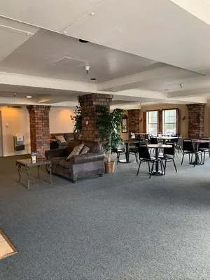 a living room with a couch and tables and chairs at Hardman House in Carson City