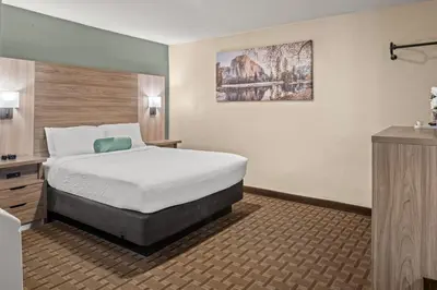 a hotel room with a bed and a sink at Buck Meadows Lodge in Groveland