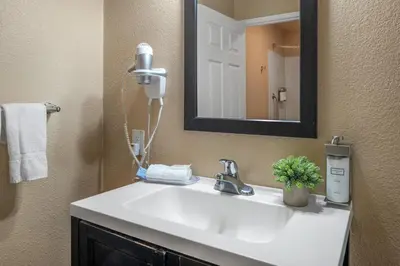 a bathroom with a white sink and a mirror at Buck Meadows Lodge in Groveland