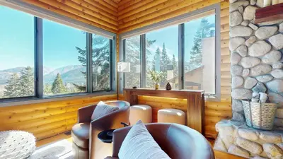 a living room with a couch and a large window at Bridges Townhome #11 Townhouse in Mammoth Lakes