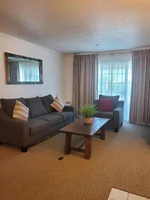 a living room with a couch and a coffee table at Sequoia Inn in Hanford