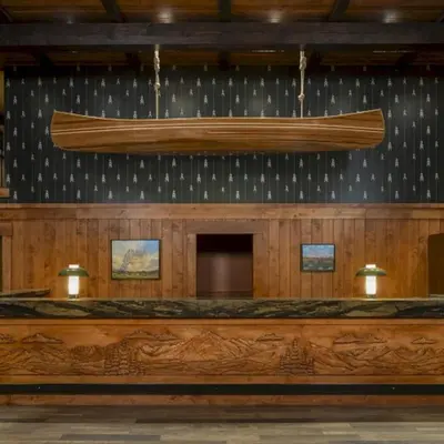 a large boat hanging from the wall of a courtroom at Wayfinder Bishop in Bishop
