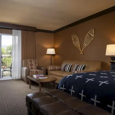 a hotel room with a bed and a couch at Wayfinder Bishop in Bishop