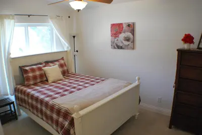 a bedroom with a bed with a plaid blanket at Big Tom's Cabin by Yosemite, lake and trails in Groveland
