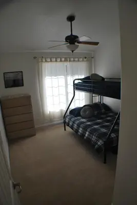 a bedroom with two bunk beds and a window at Big Tom's Cabin by Yosemite, lake and trails in Groveland