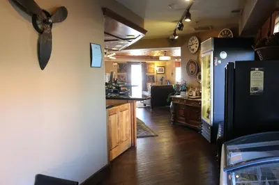 a kitchen with a black refrigerator and a counter at Historian Inn in Gardnerville