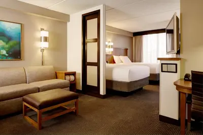 a hotel room with a bed and a couch at Hyatt Place Reno/Tahoe Airport in Reno
