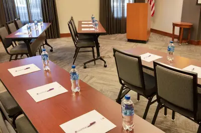 a room with tables and chairs with water bottles on them at Hyatt Place Reno/Tahoe Airport in Reno