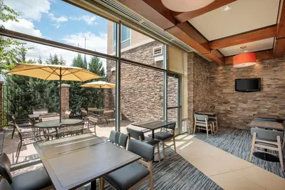 a patio with tables and chairs and windows at Hyatt Place Reno/Tahoe Airport in Reno