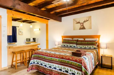a bedroom with a bed and a desk in a room at The Washoe Lodge in South Lake Tahoe