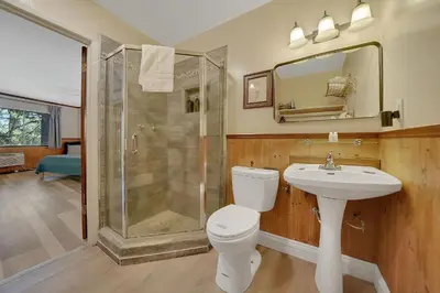 a bathroom with a shower and a toilet and a sink at Narrow Gauge Inn in Fish Camp