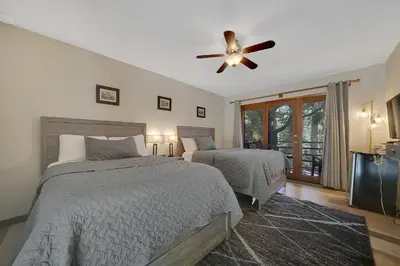 a bedroom with two beds and a ceiling fan at Narrow Gauge Inn in Fish Camp