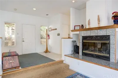 a living room with a fireplace and a room with at Pine Arbor Retreat in Yosemite West