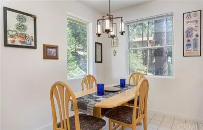 a dining room with a table and chairs and a window at Pine Arbor Retreat in Yosemite West