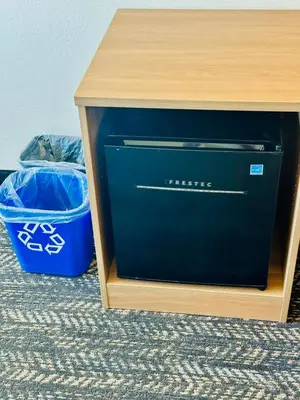 a blue printer sitting next to a wooden table at Ramada by Wyndham Merced in Merced