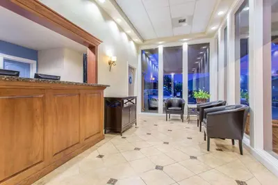 a waiting room with chairs and a podium and a table at Days Inn by Wyndham Modesto in Modesto