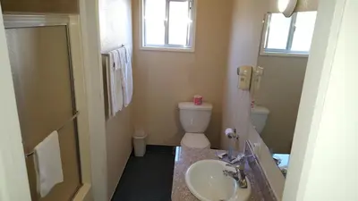 a bathroom with a sink and a toilet at Reedley Inn in Reedley