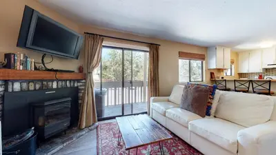 a living room with a couch and a fireplace at La Vista Blanc #61 Condo in Mammoth Lakes