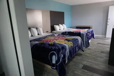 a hotel room with two beds in a room at Thunderbird Motel in Bishop