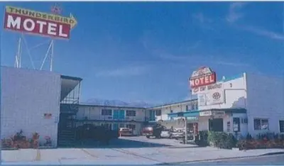 a motel with a motel sign on top of it at Thunderbird Motel in Bishop