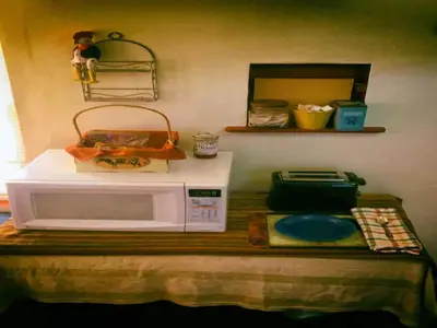 a microwave sitting on top of a table at Cozy Muir Cottage - In Town - Pet Friendly in Lone Pine